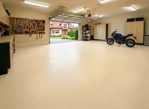 Przestronny garaż z motocyklem i posadzką w jasnym odcieniu kości słoniowej RAL 1015.